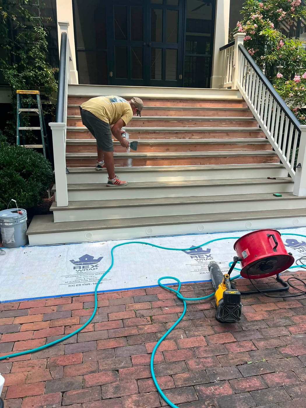 Entrance stairs renovation in progress with railings and steps under work